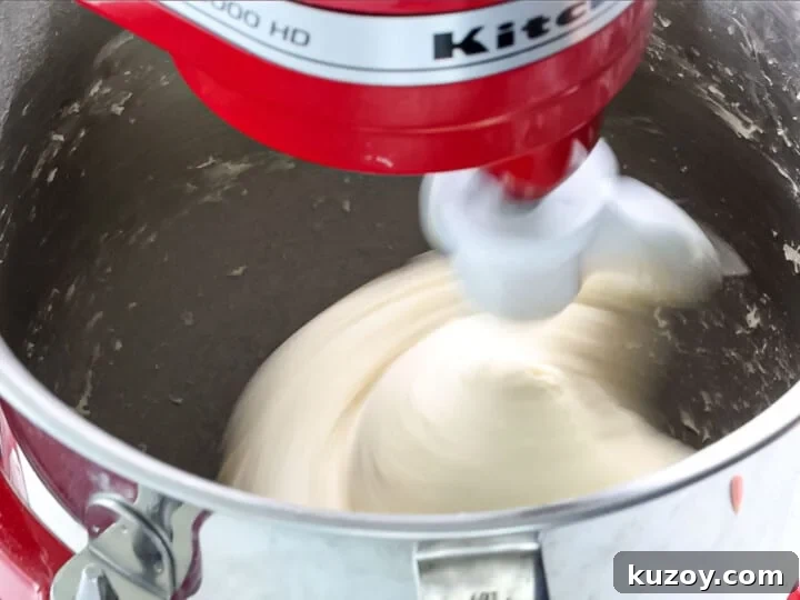 Homemade Brioche Rolls Recipe for Soft, Buttery Loaves 17 Dough being mixed in a stand mixer until it forms a ball.