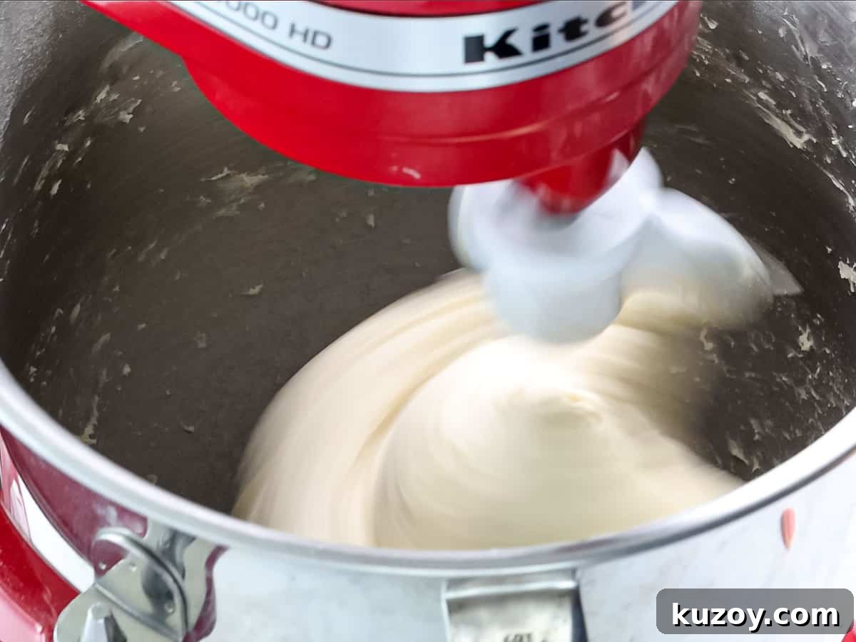 Homemade Brioche Rolls Recipe for Soft, Buttery Loaves 7 Dough being mixed in a stand mixer until it forms a ball.