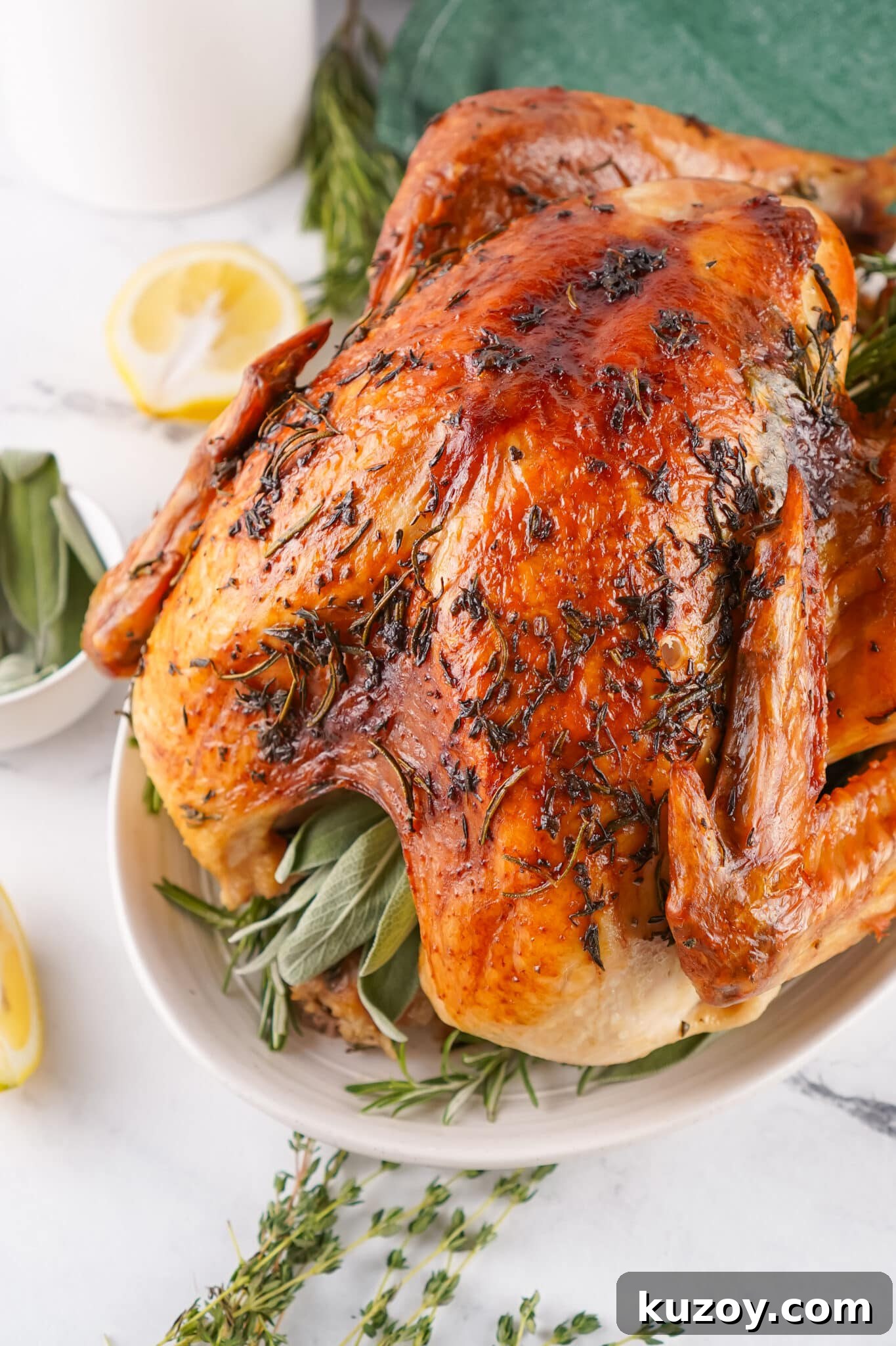 Herb-Butter Roasted Turkey Recipe for Juicy, Flavorful Results 2 top view of full herb butter roasted turkey on serving platter
