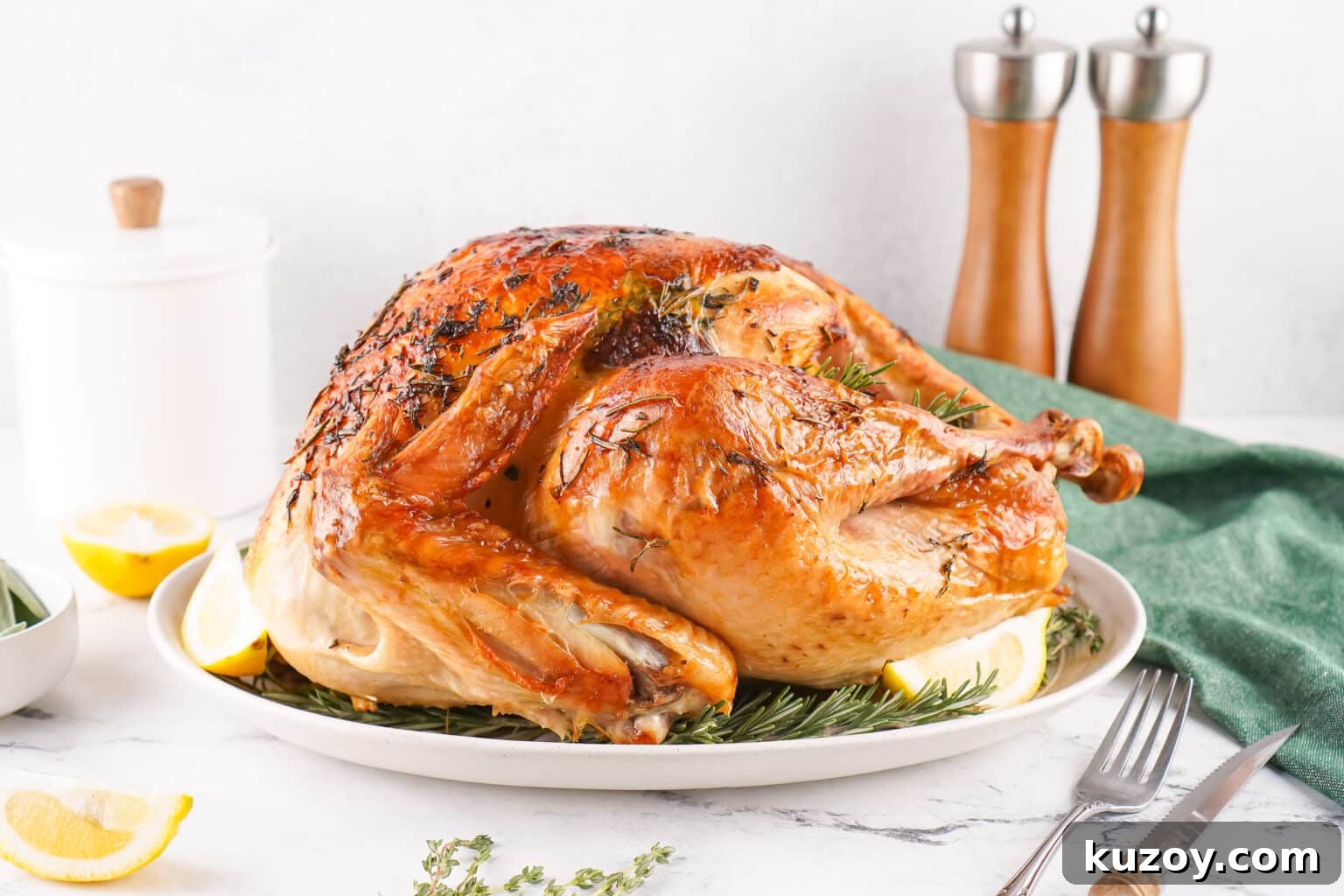 Herb-Butter Roasted Turkey Recipe for Juicy, Flavorful Results 3 side view of full herb butter roasted turkey on serving platter