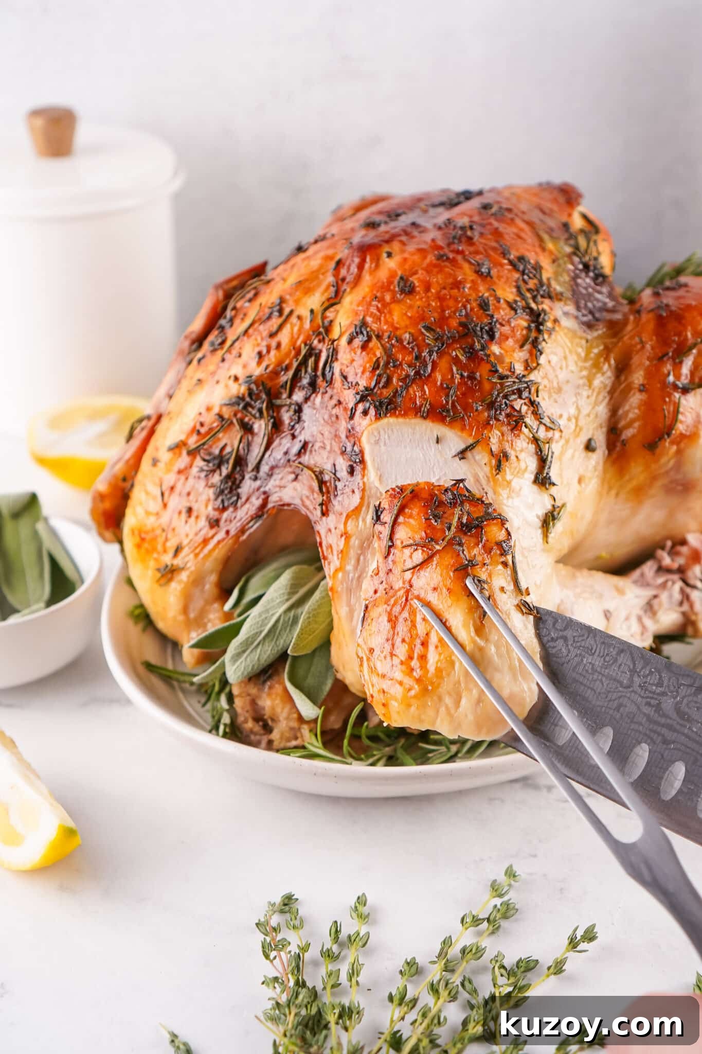 Herb-Butter Roasted Turkey Recipe for Juicy, Flavorful Results 4 knife and fork slicing piece of herb butter roasted turkey