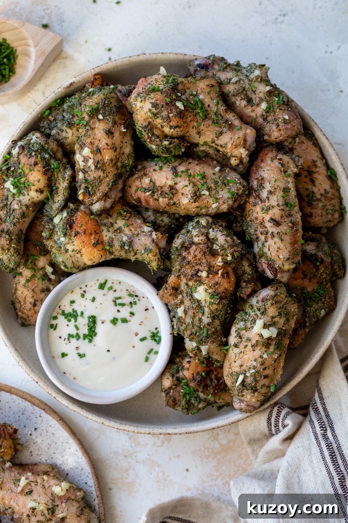 ranch chicken wings on a plate with ranch dressing on the side