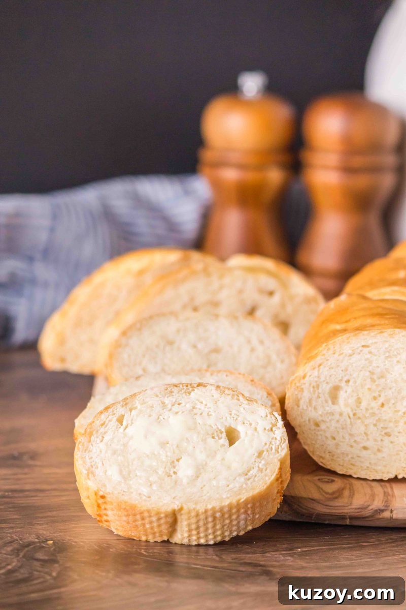 Close-up of sliced homemade French bread baguette showing soft crumb and crispy crust – Hostess At Heart- Hostess At Heart