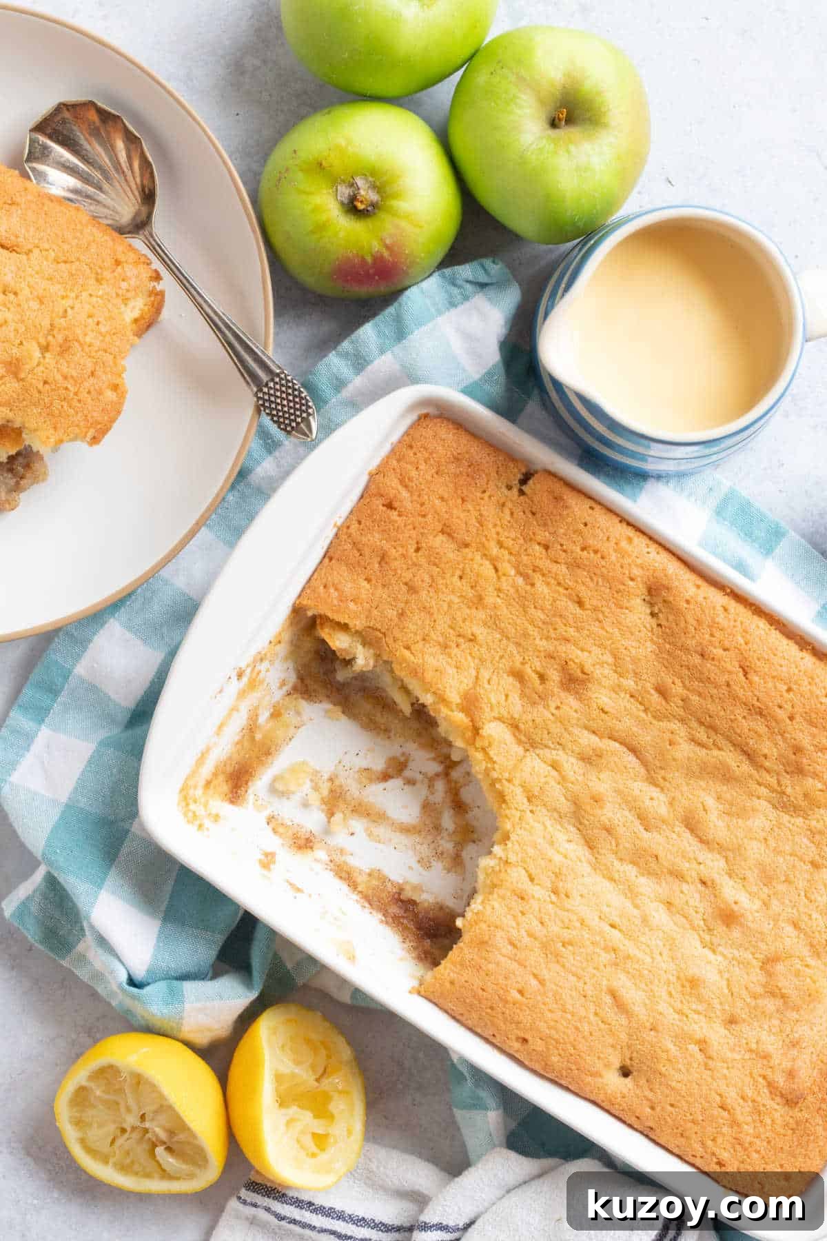 Apple sponge pudding with a jug of custard.