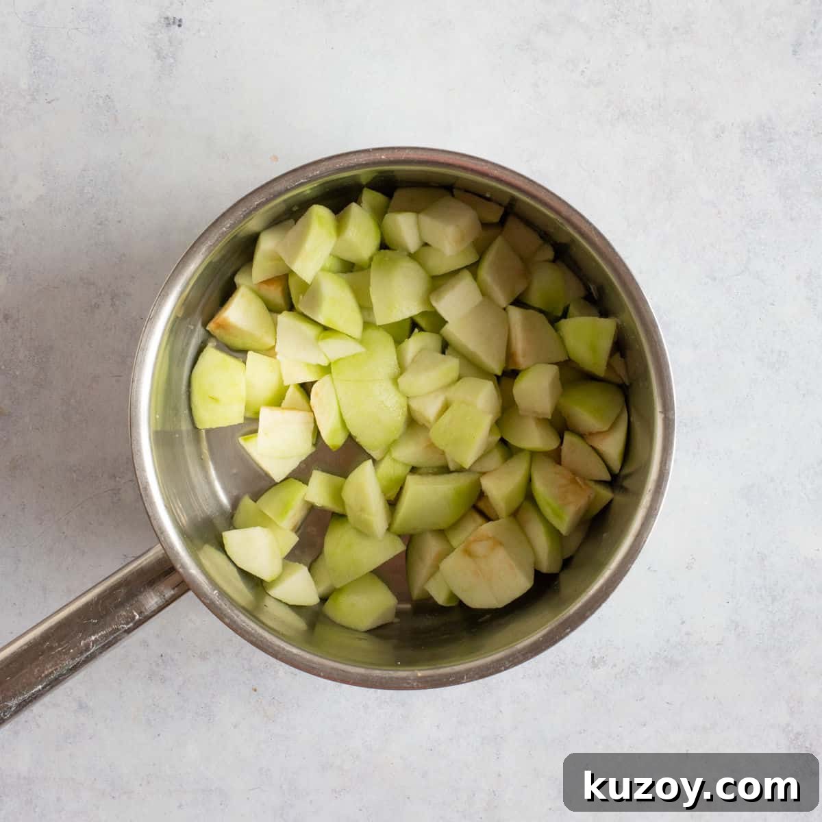 Chopped Bramley apples in a pan.