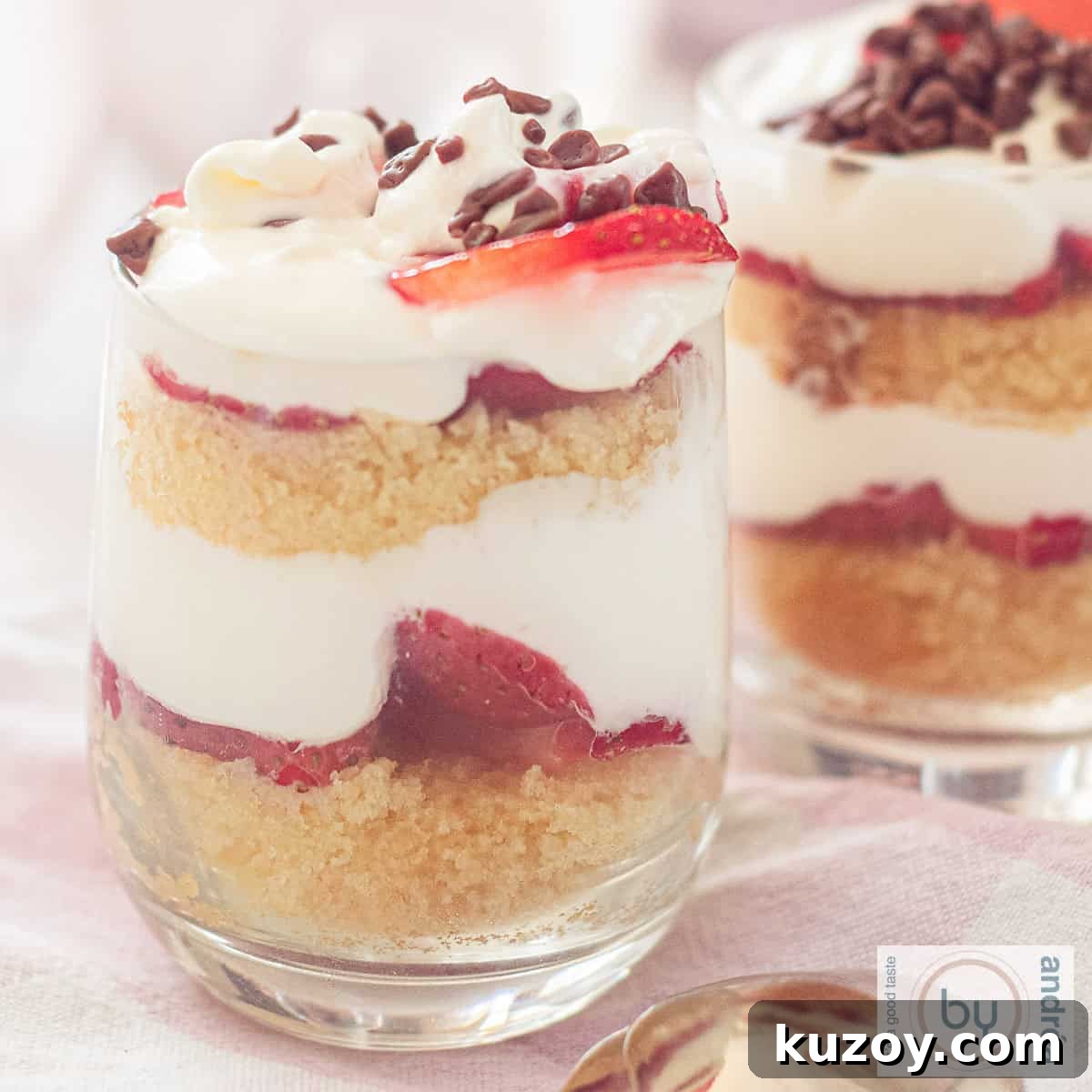 A square photo with two glasses filled with strawberry trifles