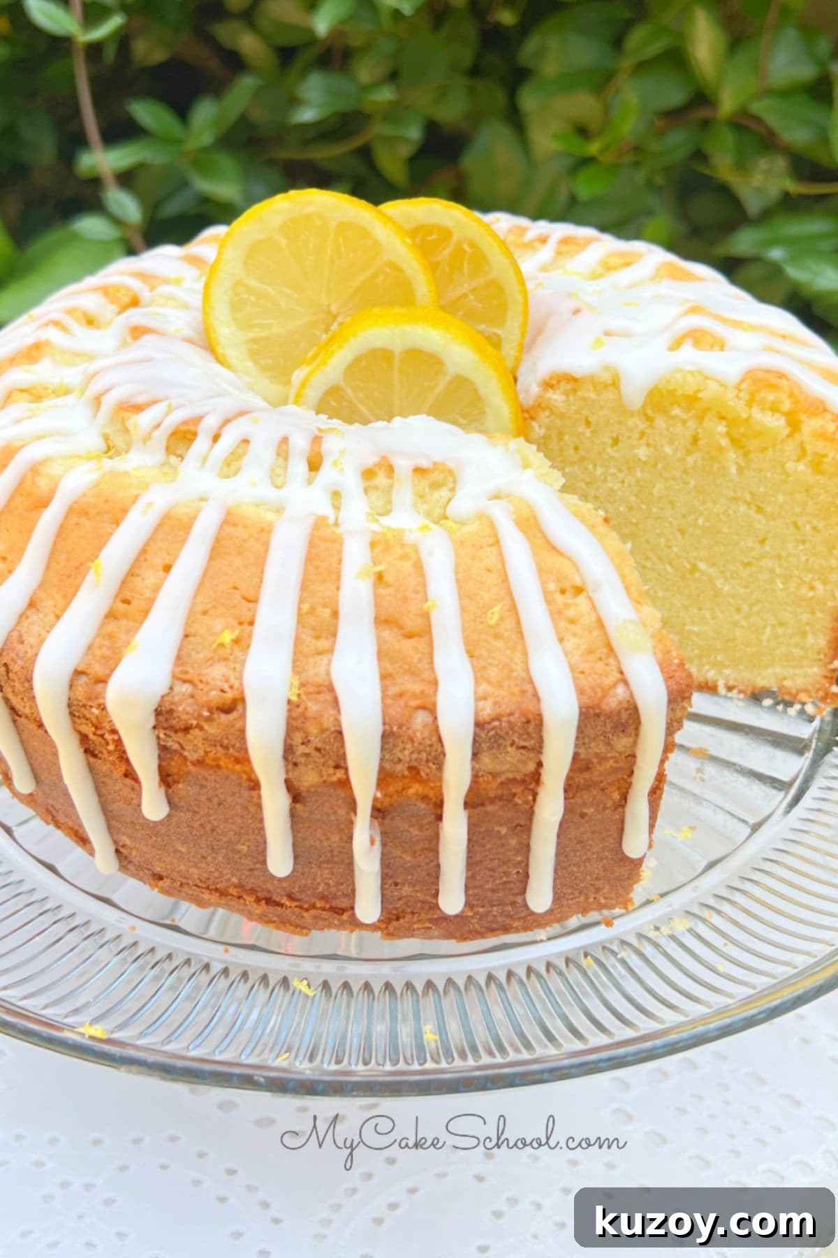 Lemon Mascarpone Pound Cake, sliced, on a pedestal.