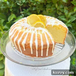 Lemon Mascarpone Pound Cake, sliced, on a pedestal.