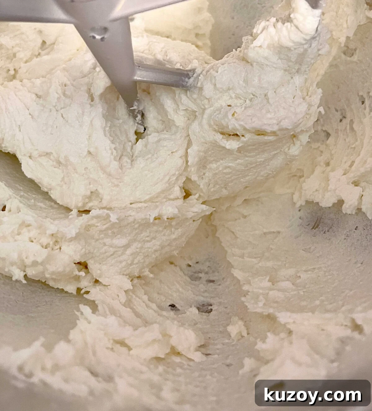 Mixing the mascarpone cheese, butter, and sugar in mixing bowl.