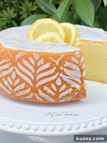 Sliced Lemon Pound Cake on a white pedestal.