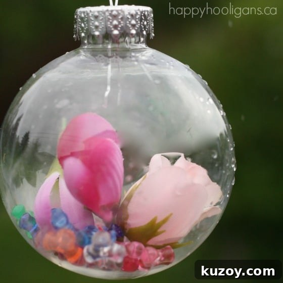 pink flowers and beads dropped into clear plastic ornament