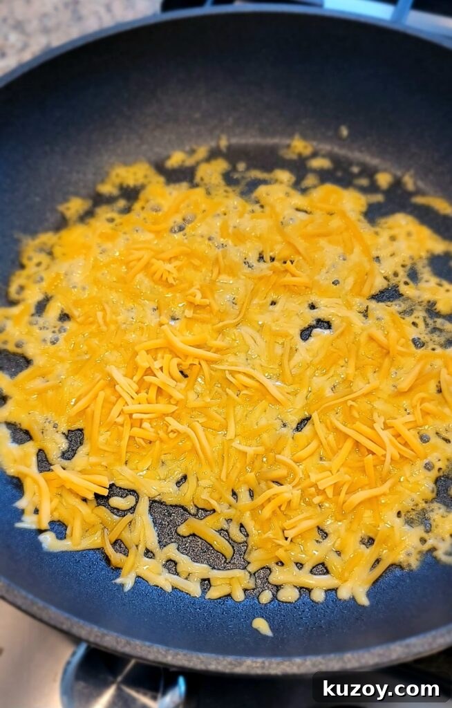 Close-up of crispy cheese layer in skillet