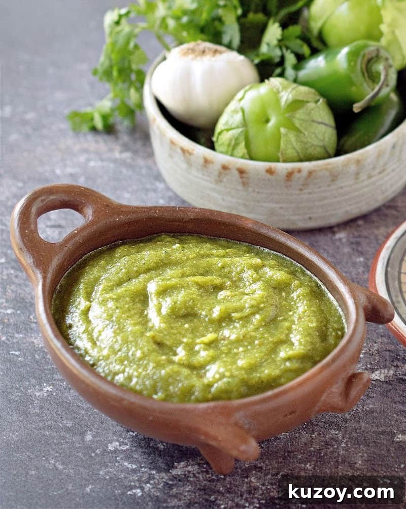 salsa verde in clay pig bowl with veggies in another bowl