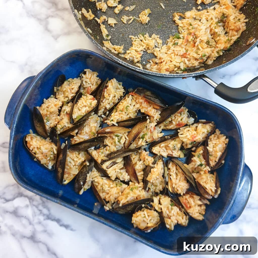 A blue baking dish filled with stuffed mussels.