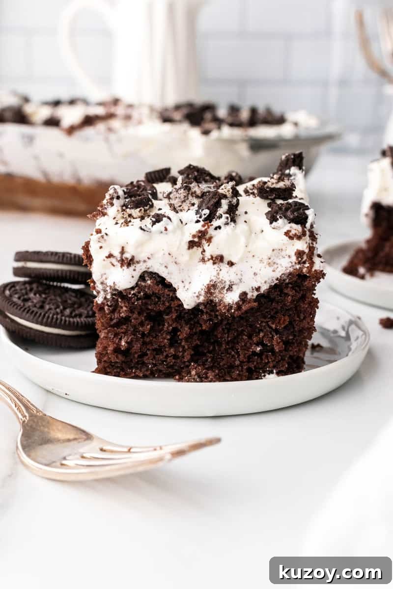 slice of Oreo poke cake on white plate