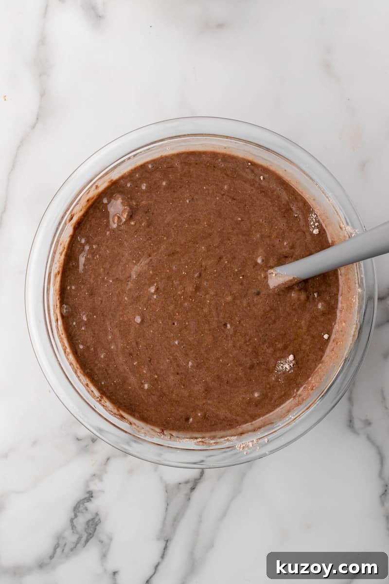 mixing the cake batter for the Oreo Poke Cake