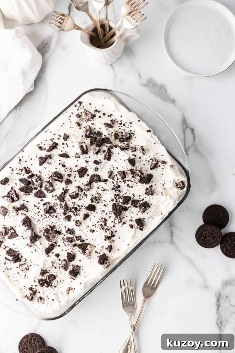 Oreo poke cake in baking dish on marble counter
