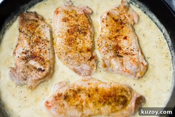 Pork chops added back into skillet with the sauce