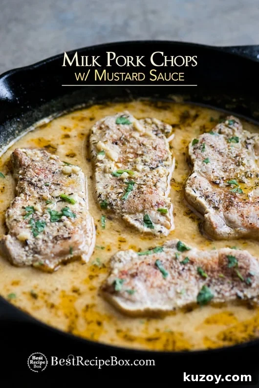 Juicy Pork Chops Braised in Milk with Mustard Sauce in a cast iron skillet 