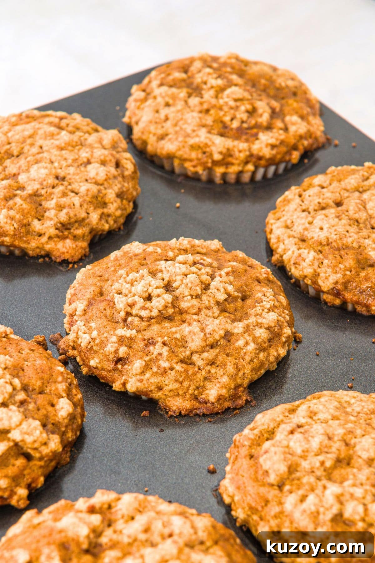 Freshly baked gluten-free banana pumpkin muffins in muffin pan