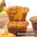 A stack of half-eaten gluten-free pumpkin banana muffins.