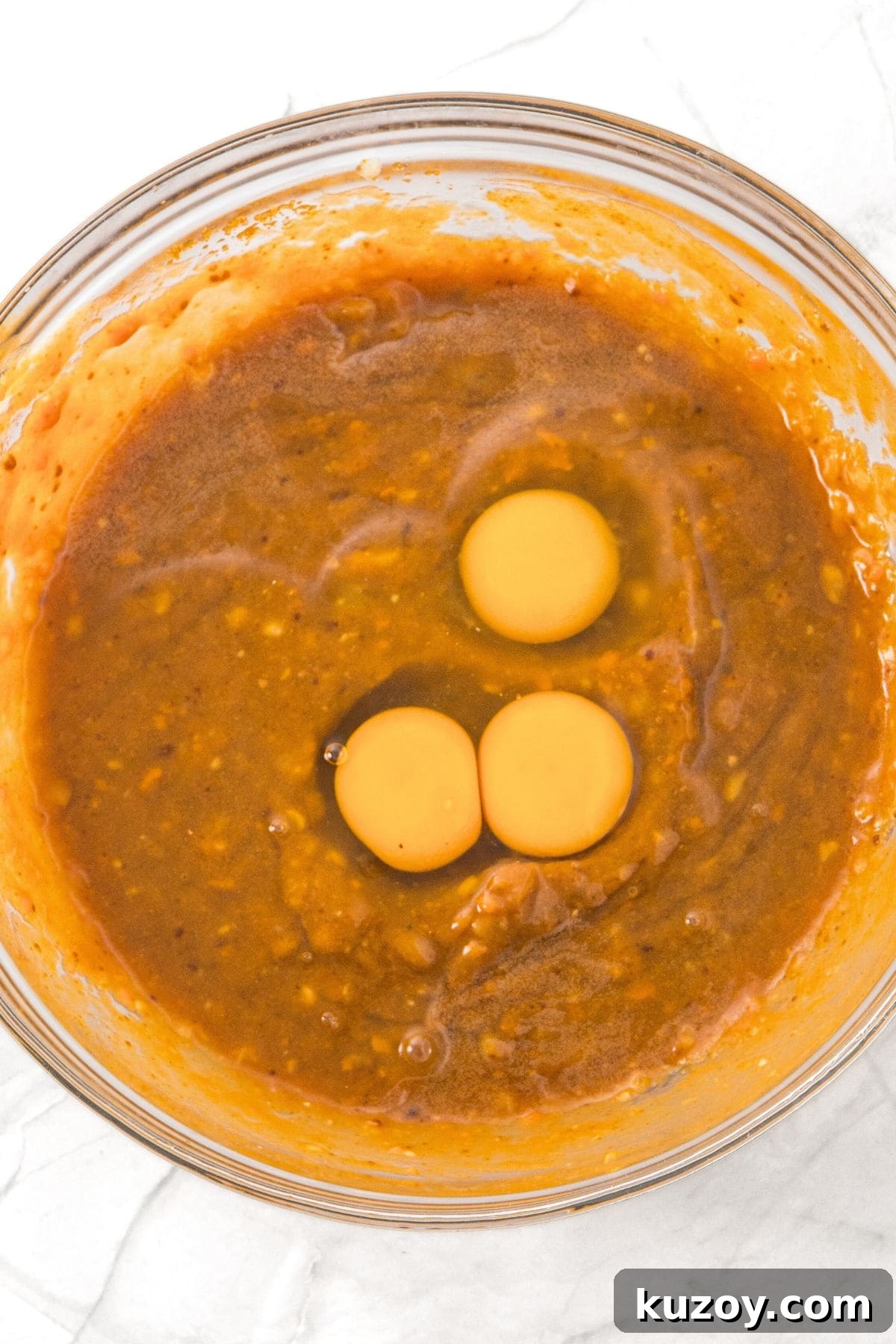 Eggs in brown muffin batter