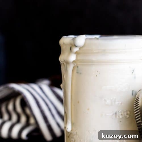 Buttermilk ranch in a jar with herbs.