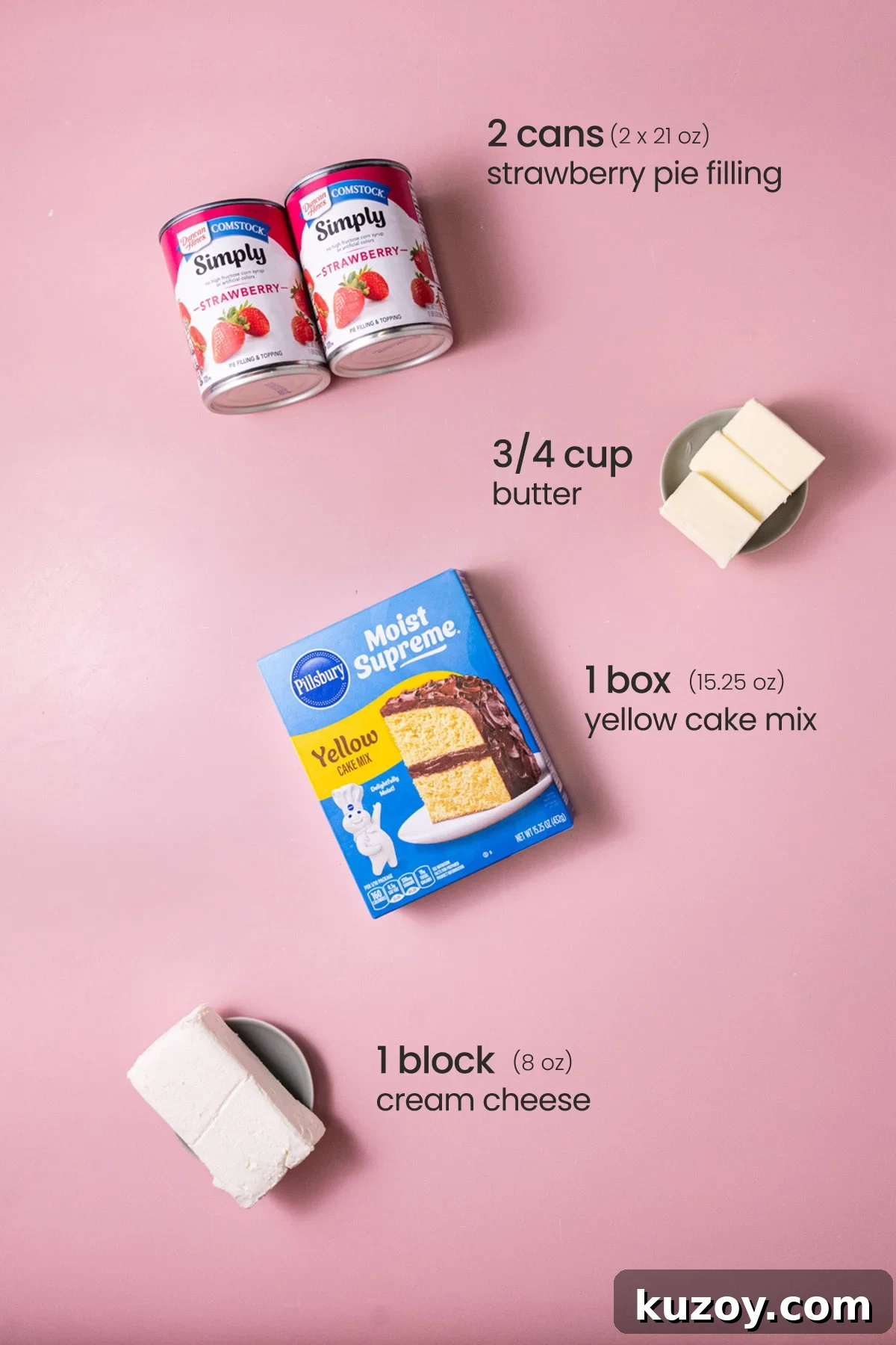 Overhead view of the ingredients needed for strawberry cheesecake dump cake - strawberry pie filling, butter, yellow cake mix, and cream cheese.