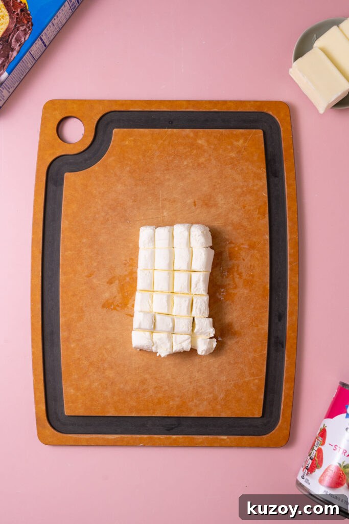 Block of cream cheese cut into small cubes. 