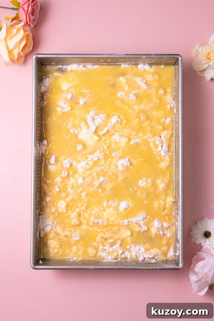 Melted butter poured over layers of yellow cake mix, cream cheese, and strawberry filling. 