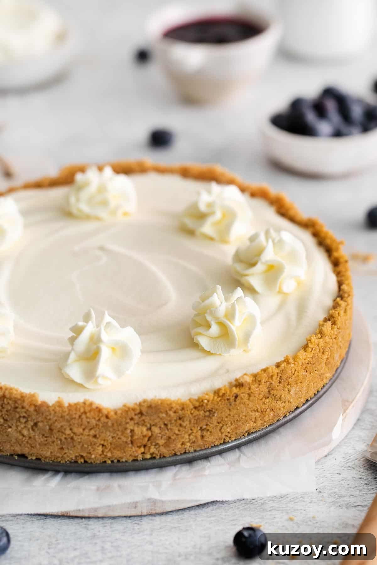 A whole gluten-free no-bake cheesecake on a serving dish