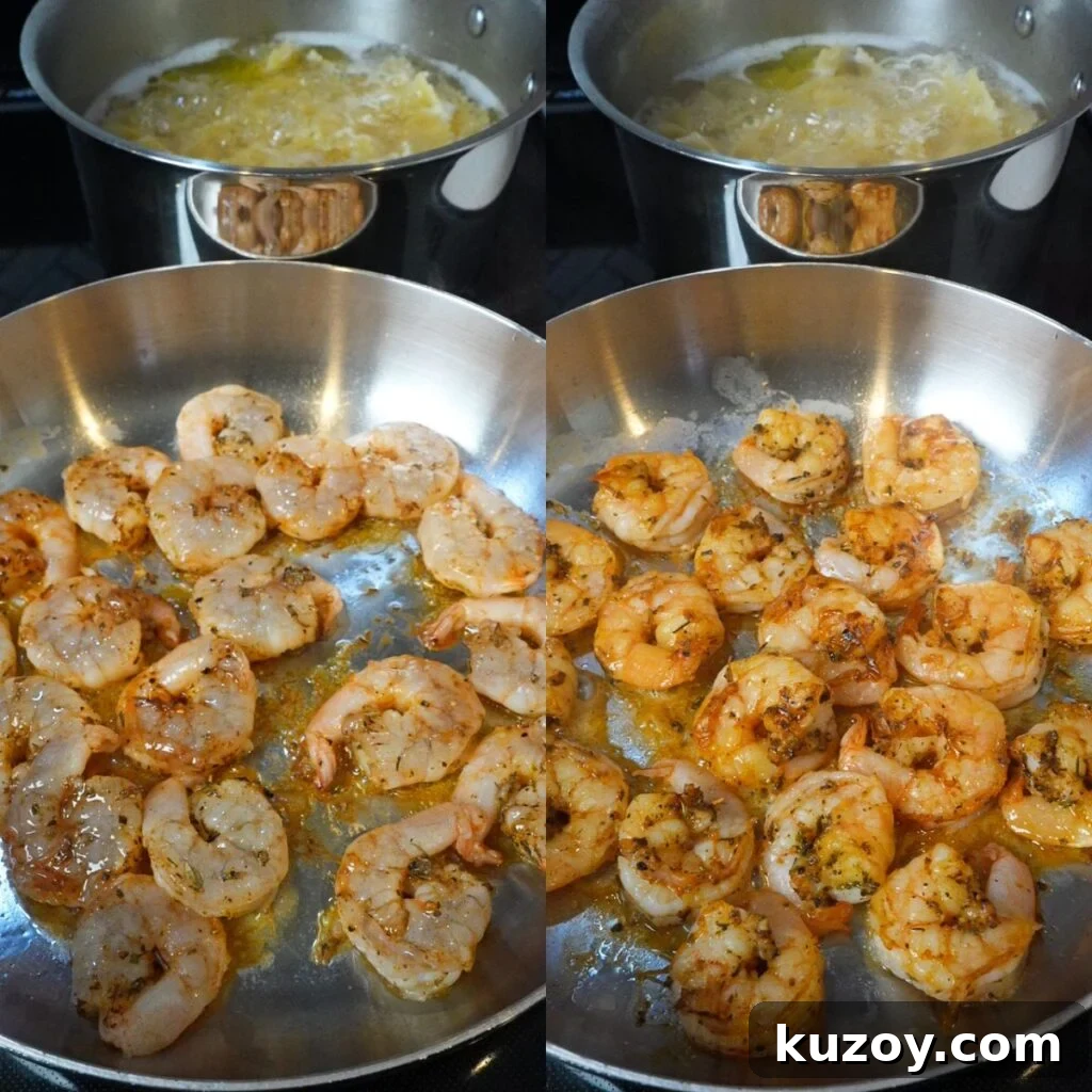 Shrimp cooking in a skillet with pasta in the background.